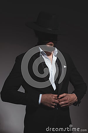 Attractive businessman with black hat and undone bowtie Stock Photo