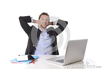 Attractive businessman happy at work smiling relaxed at computer desk Stock Photo