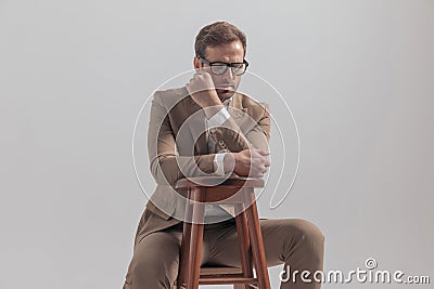 Businessman sitting in a corner and being dramatic Stock Photo