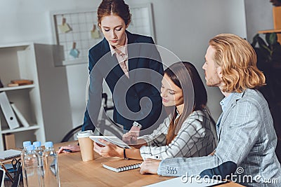 attractive businesspeople looking at tablet Stock Photo