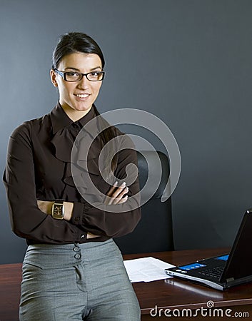 Attractive businesswoman against office desk Stock Photo