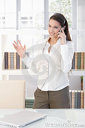 Attractive businesswoman talking on mobile smiling Stock Photo