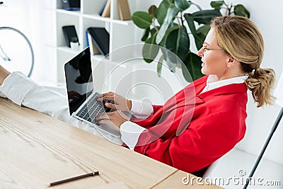 attractive businesswoman working with laptop and legs on table Stock Photo