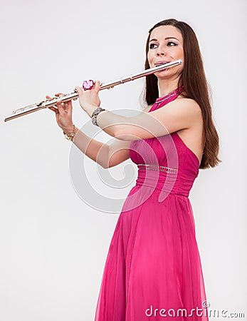 Attractive Caucasian woman a flutist playing on silver flute Stock Photo