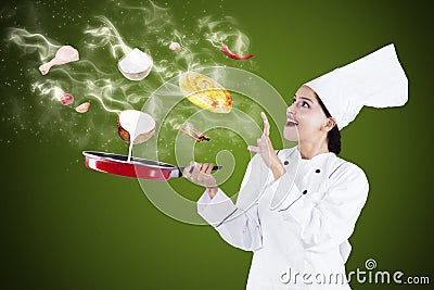 Attractive chef cooking with magic Stock Photo