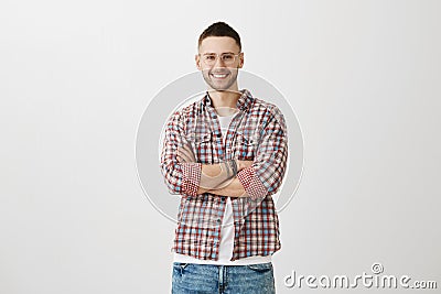 Attractive coach ready to offer his help. Portrait of charming slender man with beard in trendy outfit and eyeglasses Stock Photo