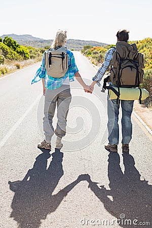 Attractive couple standing on the road holding hands Stock Photo