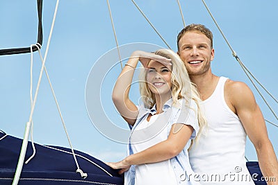 Attractive couple standing on sailing boat - sailing trip. Stock Photo