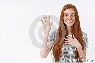 Attractive cute lovely redhead young girl blue eyes raise one hand hold palm heart promise give oath pledge loyalty Stock Photo