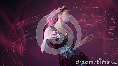 Attractive dancing blonde in the club, neon light, motion effects Stock Photo