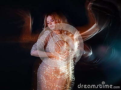 Attractive dancing blonde in the club, shining golden light, motion effects. Stock Photo