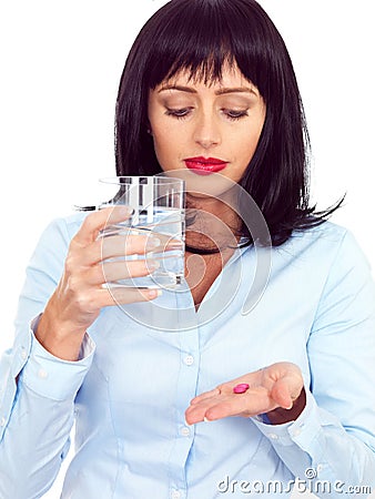 Attractive Dark Haired Young Woman Holding a Glass and Taking Medicine Stock Photo