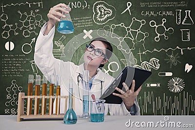 Attractive doctor examine chemical at laboratory Stock Photo