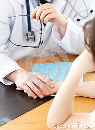 Attractive doctor holding hand of patient Stock Photo