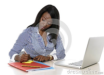 Attractive and efficient black ethnicity woman writing on notepad at office computer laptop desk Stock Photo