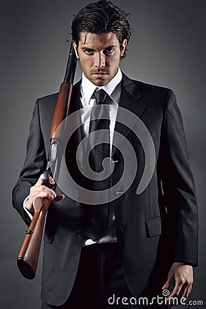 Attractive and elegant man posing with shotgun Stock Photo