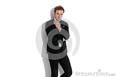 Attractive fashion businessman posing with attitude and folding his arms Stock Photo