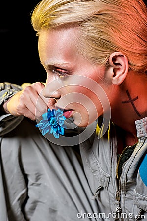 attractive female alien in spacesuit with blue flower Stock Photo
