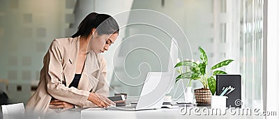 Attractive female designer holding her mobile phone. Stock Photo