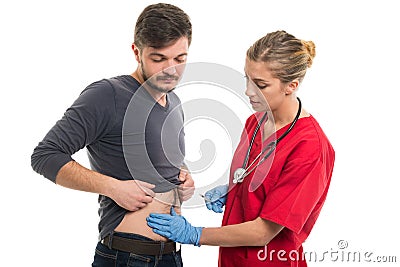 Attractive female doctor making injection to male patient Stock Photo