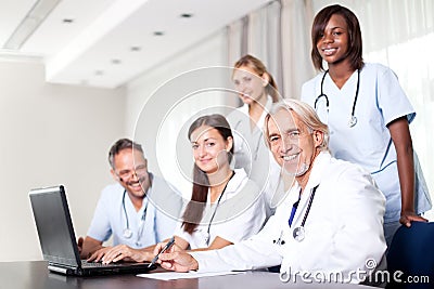 Attractive female doctor working on her laptop Stock Photo