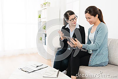 Attractive female insurance agent using mobile pad Stock Photo