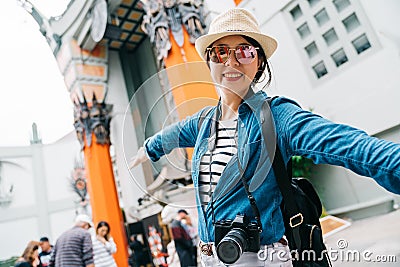 An attractive female traveler opening her arms Editorial Stock Photo