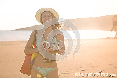 Attractive fit trendy modern hipster woman taking photos with retro vintage film camera.Lifestyle photographer Stock Photo