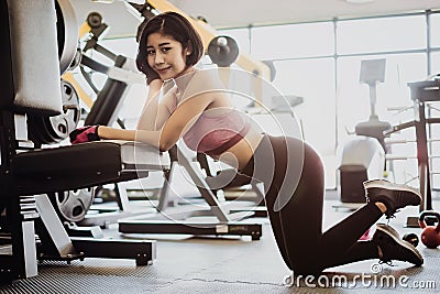 Attractive fit woman relaxing after workout in gym fitness. Portrait sport and Healthy concept Stock Photo
