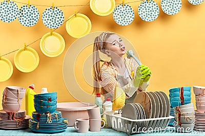 Attractive girl being in good temper., holding brush as a microphone Stock Photo