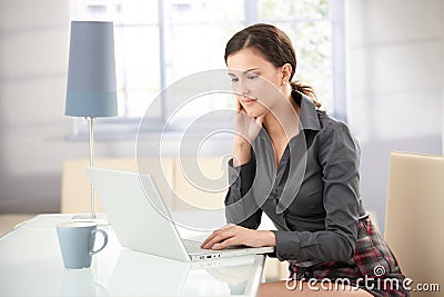 Attractive girl browsing internet at home Stock Photo