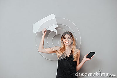 Attractive girl holding blank screen mobile phone and speech bubble Stock Photo