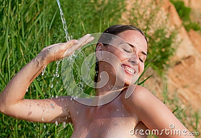 Attractive girl under running water Stock Photo