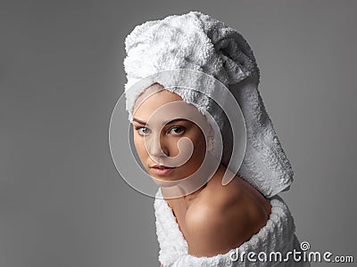 Attractive girl wearing white towel on head and white bath robe, smiling Stock Photo