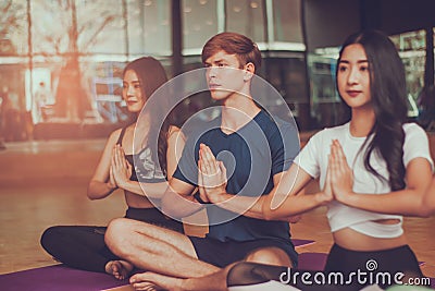 Attractive group of young multi-ethnic diversity,exercise and yoga with meditation lesson classes in studio,with concept of Stock Photo