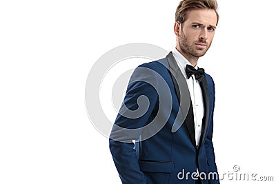 Attractive guy in tuxedo standing with hand in pocket Stock Photo