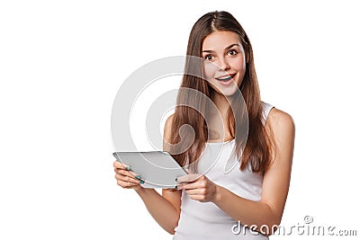 Attractive happy girl in white shirt using tablet. Excited woman with tablet pc, isolated on white background Stock Photo