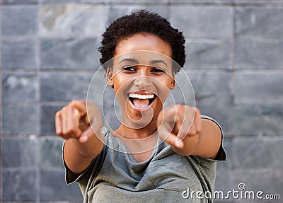 Attractive happy young black woman pointing fingers Stock Photo