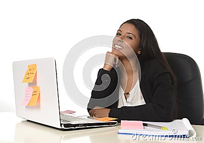 Attractive hispanic businesswoman sitting at office desk working on computer laptop smiling happy Stock Photo