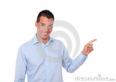 Attractive hispanic man pointing to his left Stock Photo