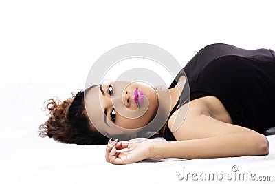 Attractive Hispanic Woman Reclining On Back Black Top Stock Photo