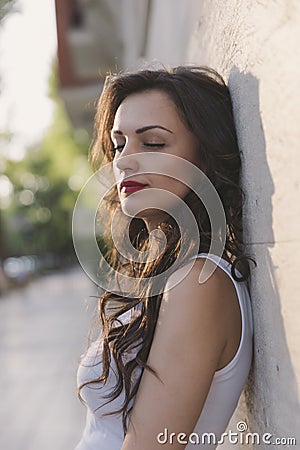 Attractive laughing female standing against wall background Stock Photo