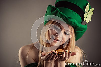 Attractive leprechaun girl with coins in hands Stock Photo