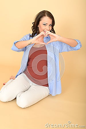 Attractive Lustful Romantic Happy Young Woman Making Heart Shape with Hands Stock Photo