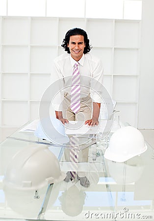 Attractive male engineer studying blueprints Stock Photo