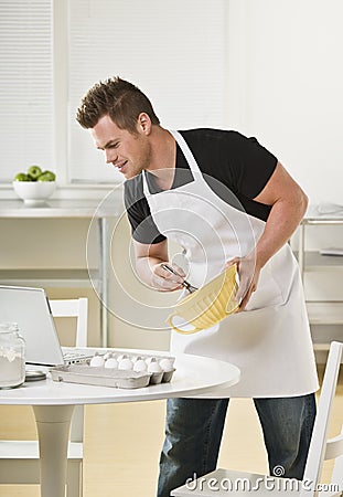 Attractive male with mixing bowl Stock Photo