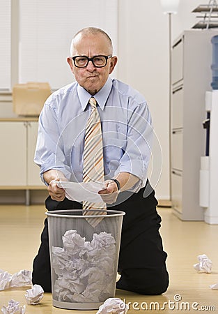 Attractive male senior searching the garbage. Stock Photo