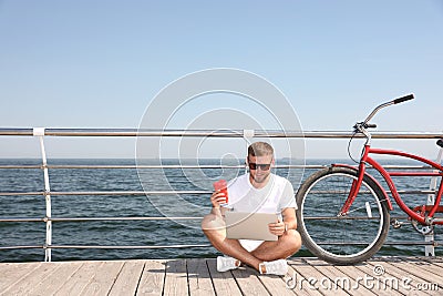 Attractive man with laptop and bike near Stock Photo