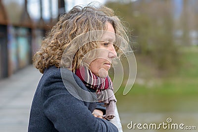 Attractive middle-aged woman deep in thought Stock Photo