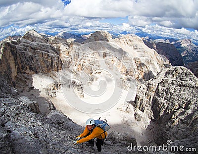 Attractive mountain climber on a steep and hard Via Ferrata climb in the Italian Dolomites Stock Photo